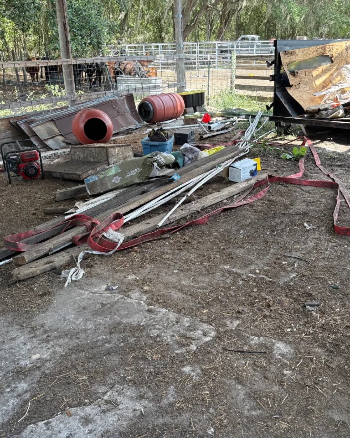 Wood, metal, and outdoor project debris staged near a roll-off container